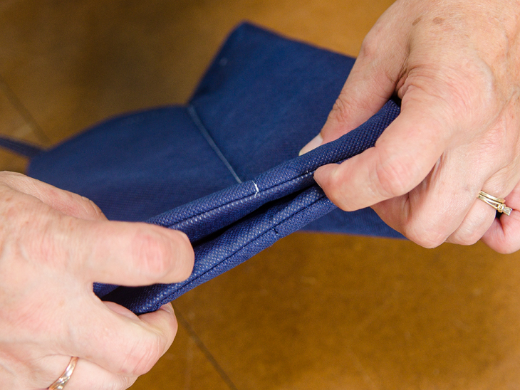 Lay the back seam against the front seam. Tuck the base of the bag up in between the seams and pin it all together.